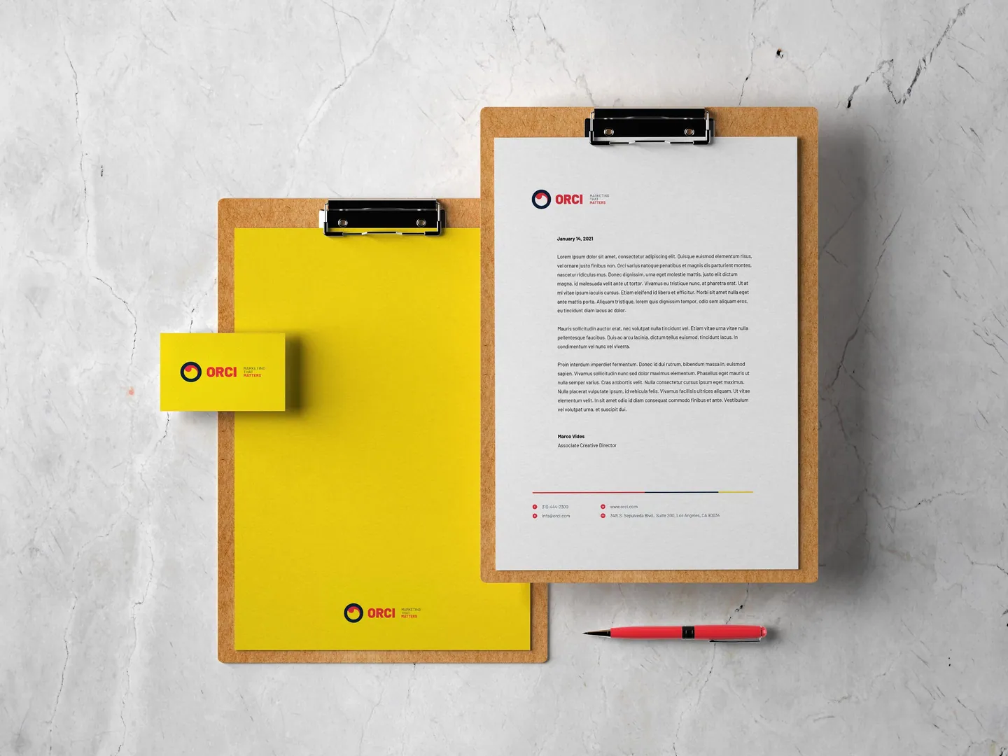 Orci letterhead and yellow notebook on clipboards.